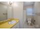 Bathroom featuring a single sink vanity, a toilet and a shower with a window at 7320 Ritter Dr, Charlotte, NC 28270