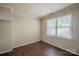 A bright bedroom features wood floors and a window with natural light at 7320 Ritter Dr, Charlotte, NC 28270