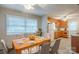 A dining area features a light wood table, six chairs, and a view of the spacious kitchen at 7320 Ritter Dr, Charlotte, NC 28270