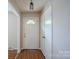 Inviting entryway with a white front door and warm wood-look floors at 7320 Ritter Dr, Charlotte, NC 28270