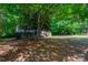 A charming home with a lush, green lawn, nestled beneath the shade of mature trees at 7320 Ritter Dr, Charlotte, NC 28270