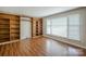 Bright living room featuring hardwood floors and built-in wooden bookshelves at 7320 Ritter Dr, Charlotte, NC 28270