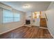 Spacious living room featuring a classic fireplace and stairs to an upper area at 7320 Ritter Dr, Charlotte, NC 28270