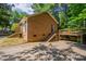 The back of this brick home features a concrete patio and stairs leading to an upper deck at 7320 Ritter Dr, Charlotte, NC 28270