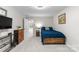 Cozy bedroom featuring a wooden bed frame and a stylish dresser at 7798 Sand Trap Ln, Stanley, NC 28164