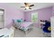 Cozy bedroom with a ceiling fan, natural lighting, and purple walls at 7798 Sand Trap Ln, Stanley, NC 28164