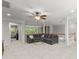 Open bonus room with ceiling fan, natural light, and sectional couch at 7798 Sand Trap Ln, Stanley, NC 28164