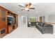 Bonus room with large television, sectional couch, and ceiling fan at 7798 Sand Trap Ln, Stanley, NC 28164