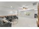 Large bonus room with natural light, sectional couch, and ceiling fan at 7798 Sand Trap Ln, Stanley, NC 28164