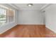 Bright, airy room with hardwood floors, neutral walls, large windows, and classic trim at 7798 Sand Trap Ln, Stanley, NC 28164