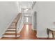Spacious entrance featuring hardwood floors, an open staircase, and recessed lighting at 7798 Sand Trap Ln, Stanley, NC 28164
