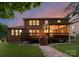 The back of a brick home, with a manicured lawn and stone path at 7798 Sand Trap Ln, Stanley, NC 28164