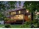 The exterior of a brick home, with a deck and an enclosed porch at 7798 Sand Trap Ln, Stanley, NC 28164