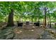Outdoor fire pit area with stone surround, perfect for entertaining with seating for four at 7798 Sand Trap Ln, Stanley, NC 28164