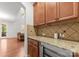 Kitchen cabinet detail featuring granite counters, custom backsplash and beverage storage at 7798 Sand Trap Ln, Stanley, NC 28164