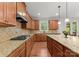 Gourmet kitchen featuring stainless steel appliances, granite counters and custom cabinetry at 7798 Sand Trap Ln, Stanley, NC 28164