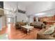 Spacious, open-concept living room showcasing hardwood floors and seamless access to an island kitchen at 7798 Sand Trap Ln, Stanley, NC 28164
