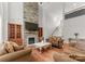 Elegant living room featuring a stone fireplace, hardwood floors, and comfortable seating at 7798 Sand Trap Ln, Stanley, NC 28164