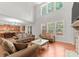 Bright living room featuring hardwood floors, many windows and seamless access to an island kitchen at 7798 Sand Trap Ln, Stanley, NC 28164