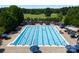 Stunning aerial view of a large swimming pool and lounge area surrounded by lush landscaping at 7798 Sand Trap Ln, Stanley, NC 28164