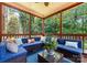 Inviting screened-in porch with ample seating and a view of the lush backyard at 7798 Sand Trap Ln, Stanley, NC 28164