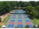 Aerial view of tennis and pickleball courts, showcasing the recreational amenities of the property at 7798 Sand Trap Ln, Stanley, NC 28164