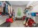 Large walk-in closet with custom shelving, bench, and window at 7798 Sand Trap Ln, Stanley, NC 28164