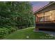 Green backyard, with a stone path and an enclosed porch at 7798 Sand Trap Ln, Stanley, NC 28164