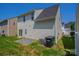 Back exterior view of the home with a gravel area and green grass at 8226 Gabon Ct, Charlotte, NC 28215
