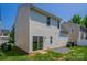 Exterior view of the home featuring a sliding glass door and a small gravel patio at 8226 Gabon Ct, Charlotte, NC 28215