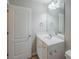 Bathroom featuring a vanity, large mirror, and adjacent linen door at 8226 Gabon Ct, Charlotte, NC 28215