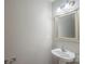 Bright half-bathroom with pedestal sink, faucet, mirror, towel rack, and neutral wall color at 8226 Gabon Ct, Charlotte, NC 28215