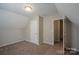Small, carpeted bedroom features a vaulted ceiling and a closet with door at 8226 Gabon Ct, Charlotte, NC 28215