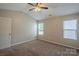 Carpeted bedroom with two windows, ceiling fan, and neutral paint at 8226 Gabon Ct, Charlotte, NC 28215