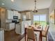 Eat in dining area featuring modern lighting fixture, dinette set, and access to the kitchen at 8226 Gabon Ct, Charlotte, NC 28215