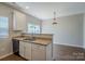 Cozy kitchen area with white cabinetry, granite countertops, and a view into the dining room at 8226 Gabon Ct, Charlotte, NC 28215