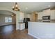 Open-concept kitchen with white cabinets, granite countertops, black appliances, and a breakfast bar at 8226 Gabon Ct, Charlotte, NC 28215