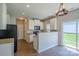 Bright kitchen area features white cabinetry, stainless appliances, and a slider to the backyard at 8226 Gabon Ct, Charlotte, NC 28215