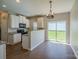 Kitchen and dining area, featuring white cabinets, granite countertops, modern appliances, and sliding glass doors at 8226 Gabon Ct, Charlotte, NC 28215