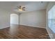 Spacious living room with hardwood floors, archway, and a ceiling fan, offering ample natural light at 8226 Gabon Ct, Charlotte, NC 28215