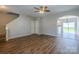 Open living room featuring hardwood floors, staircase, and a view of the kitchen and backyard at 8226 Gabon Ct, Charlotte, NC 28215