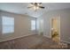 Neutral toned main bedroom with carpet flooring, ceiling fan and an ensuite bathroom at 8226 Gabon Ct, Charlotte, NC 28215