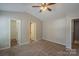 Neutral toned main bedroom with carpet flooring, ceiling fan and closet at 8226 Gabon Ct, Charlotte, NC 28215
