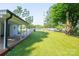 Backyard with a grassy area, chain-link fence and a view of a parked car at 100 S Rudisill Ave, Cherryville, NC 28021