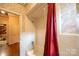 Bathroom with a shower and bathtub and a red shower curtain at 100 S Rudisill Ave, Cherryville, NC 28021