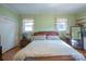 Large bedroom with hardwood floors, two windows, and built-in shelves at 100 S Rudisill Ave, Cherryville, NC 28021