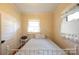 Cozy bedroom featuring neutral paint, classic white trim, and a metal bed frame at 100 S Rudisill Ave, Cherryville, NC 28021