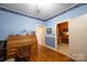 Bright home office featuring hardwood floors, a wooden rolltop desk and bonus office space at 100 S Rudisill Ave, Cherryville, NC 28021