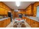 A charming kitchen boasts wood-paneled walls, countertops, and a breakfast nook perfect for enjoying meals at 100 S Rudisill Ave, Cherryville, NC 28021
