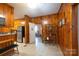 Traditional kitchen features knotty pine wood walls, a stainless steel refrigerator, and a vintage decorative shelf at 100 S Rudisill Ave, Cherryville, NC 28021